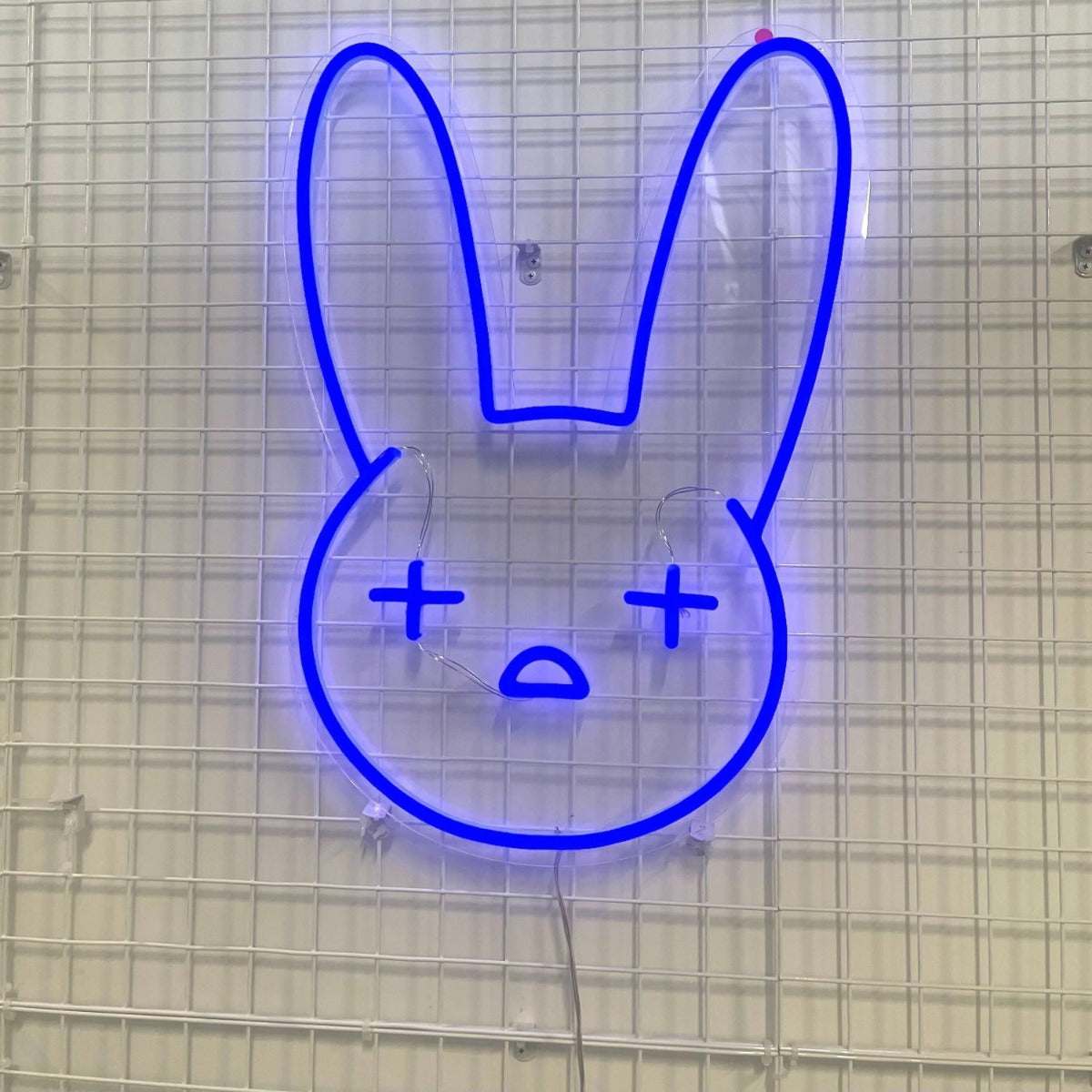 Custom Neon® blue bad bunny emoji LED art shown as lighted decor for an Easter egg hunt