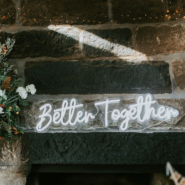 Custom Neon's gorgeous neon wedding sign "Better Together" IRL featured on a brick wall - photo from CustomNeon.com