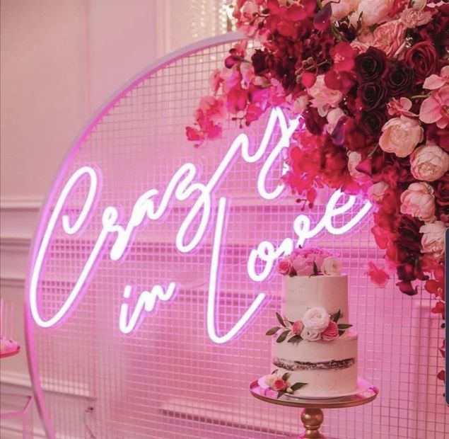 Crazy In Love Wedding Sign in brilliant LED neon flex shown in white with balloons