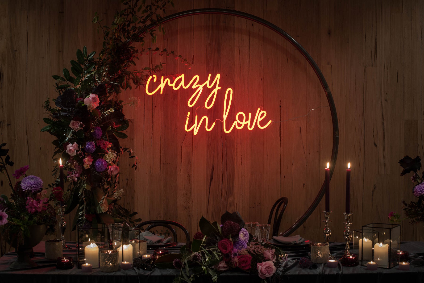 Crazy in Love Neon Wedding Sign behind the bride & groom's table - photo from CustomNeon.com