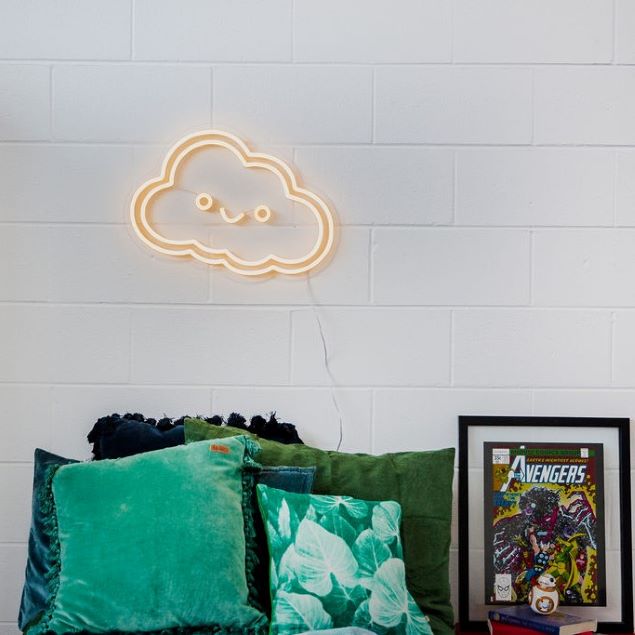 Smiley Cloud LED wall light in warm white above child's bed - by CUSTOM NEON®