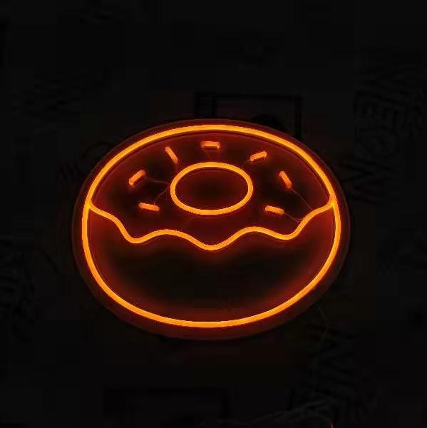 Orange donut with sprinkles LED neon sign shown turned on - made by Custom Neon®