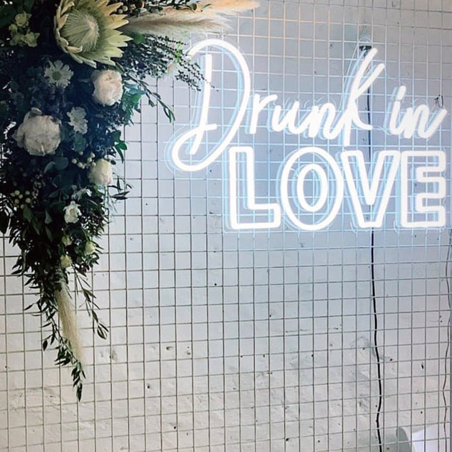 Drunk in LOVE LED neon sign shown on a mesh screen as the photo wall at an event - Custom Neon