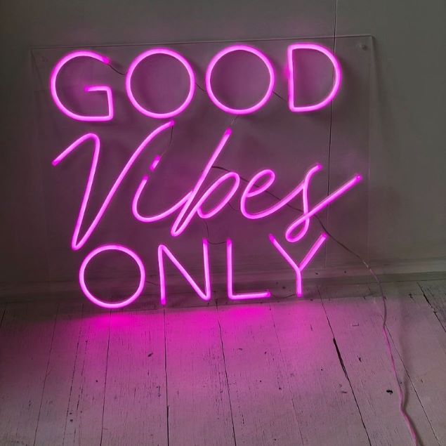 Good Vibes Only neon sign in pink shown illuminated - from Custom Neon®