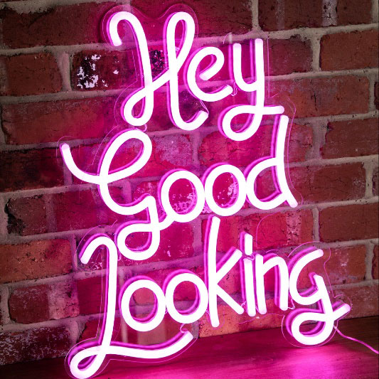 * Hey Good Looking * neon word sign shown on exposed brick wall - photo from CustomNeon.com
