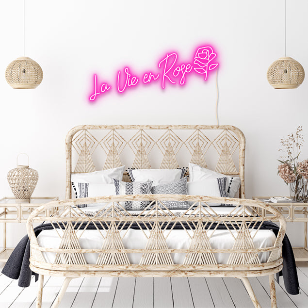 La Vie En Rose pink neon flex wall above a bed - from Custom Neon
