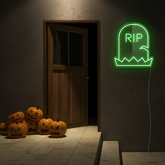 Yellow Light Up RIP Tombstone on dark wall with spooky jack-o-lanterns - CUSTOM NEON® Halloween Decorations