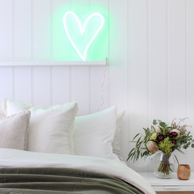 A little love heart in green shown as bedroom decor