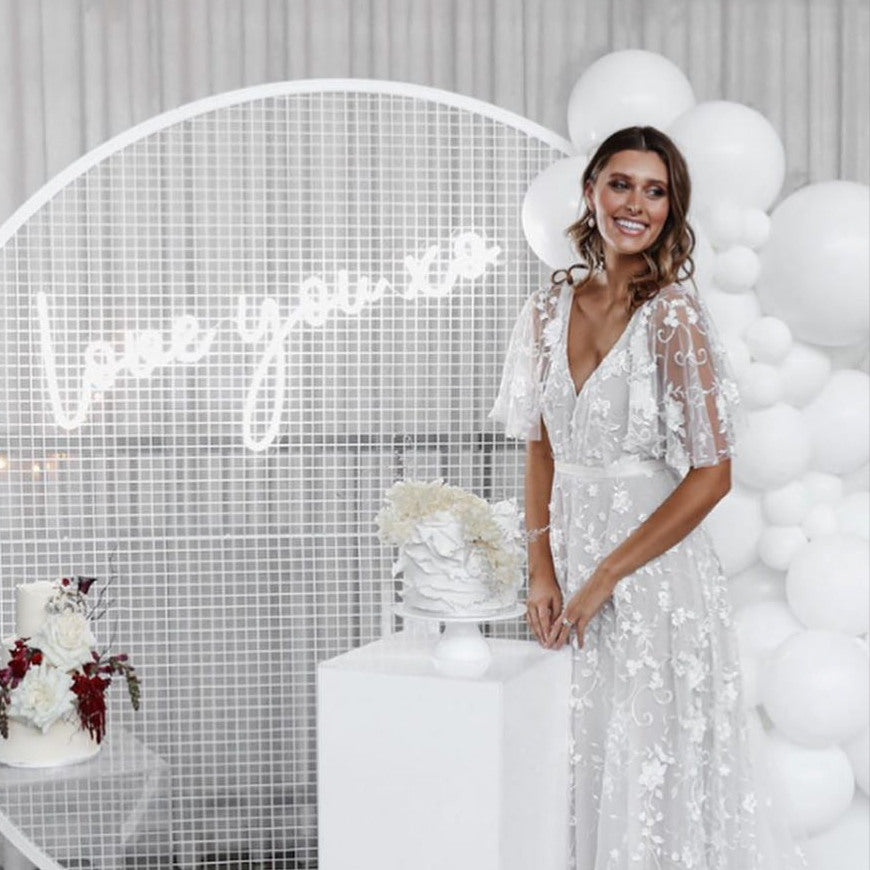Love You XO LED neon light shown on a mesh screen with balloons, wedding cakes and the beautiful bride - by CustomNeon.com @customneon
