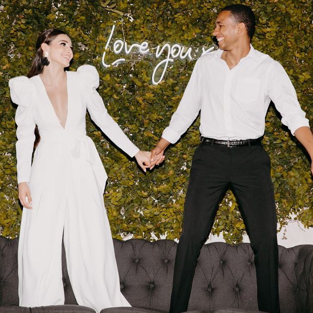 Love You XO LED neon sign in the background while the happy couple share a moment - sign by CustomNeon.com / photo by candileonardphotography.com