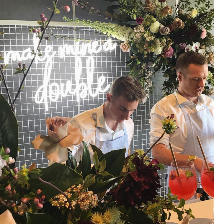 Make Mine a Double trendy LED neon bar sign behind the open bar at an event - photo from CustomNeon.com