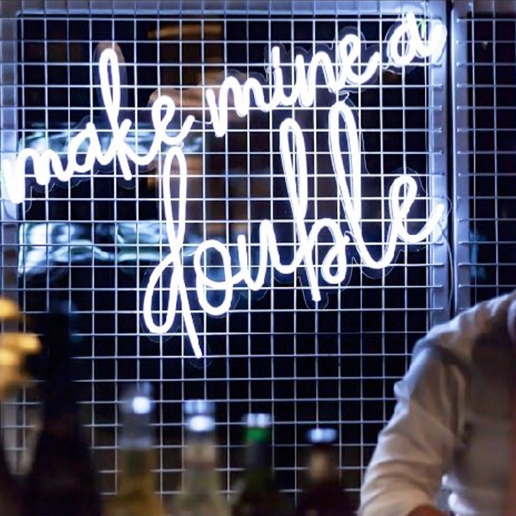 Make Mine a Double trendy LED neon bar sign behind the open bar at an event - photo from CustomNeon.com