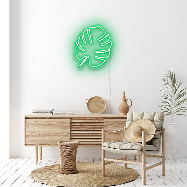 Green LED neon monstera leaf on a white wall - CUSTOM NEON®