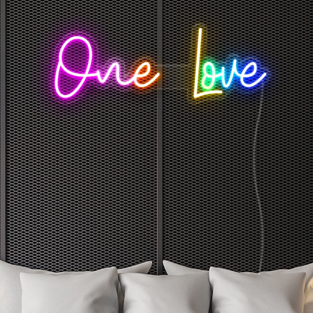 Colorful LED neon One Love word sign shown against a dark wallas bedroom décor - by Custom Neon®