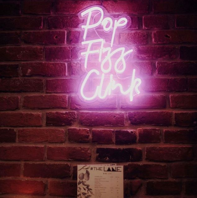 Pop Fizz Clink pink light sign as seen @down_thelane made by@customneon