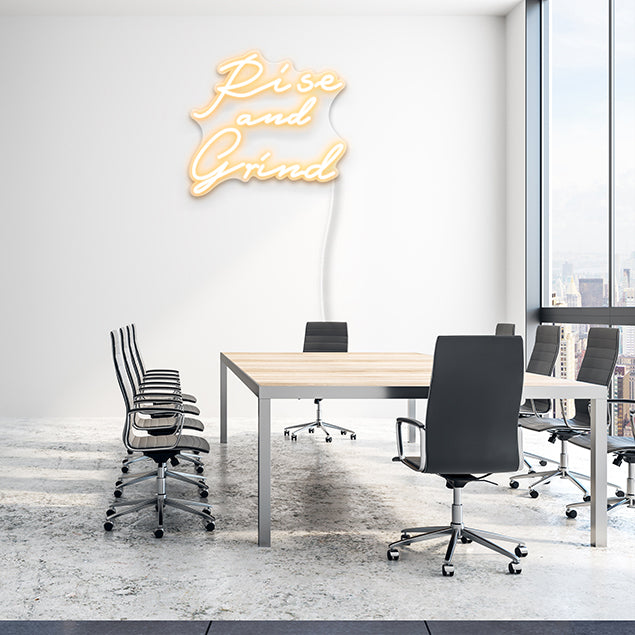 Rise and Grind off white CUSTOM NEON® sign shown on office boardroom wall