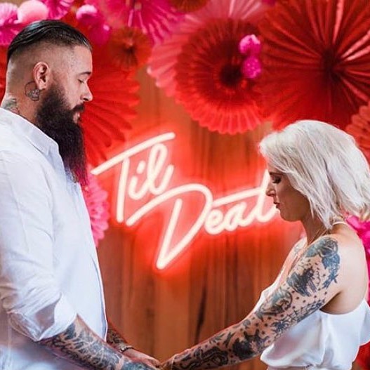 Til Death Neon Sign in LED flex shown in bright white on a green wall - photo CustomNeon.com