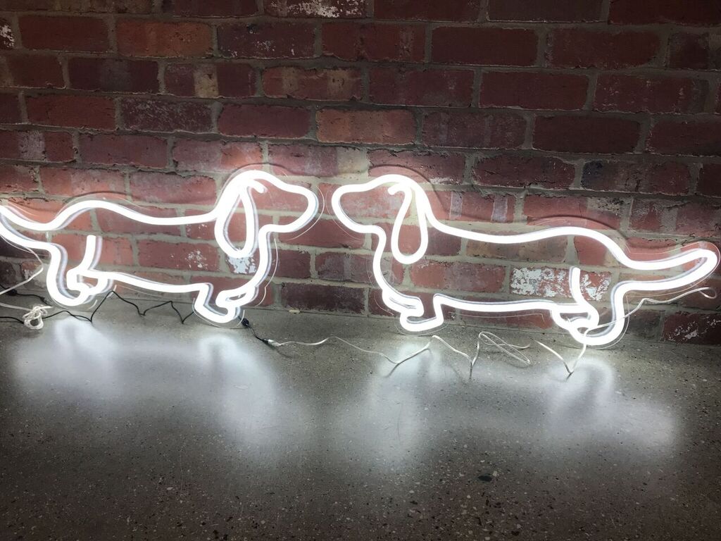 Cute Weiner Dog neon art shown against an exposed brick wall - photo from CustomNeon.com