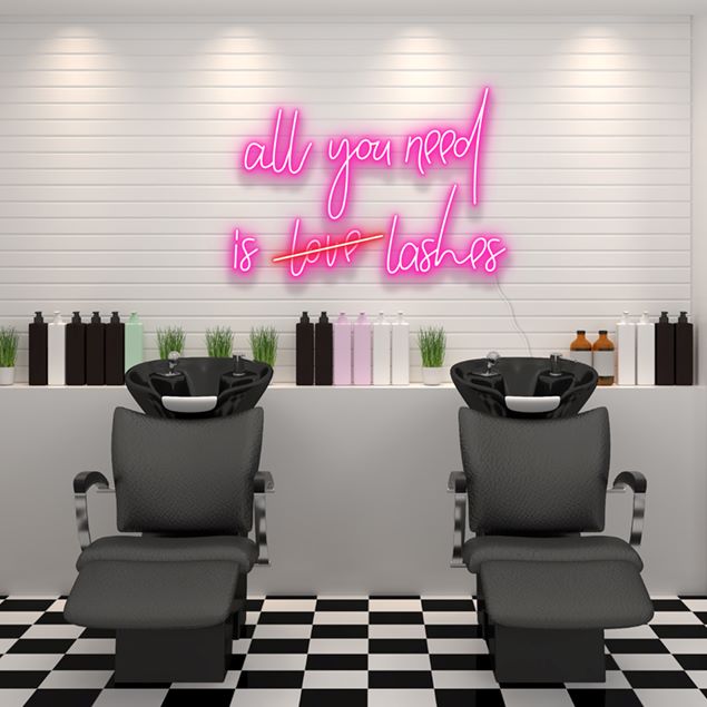 All You Need is Love Lashes pink faux neon sign shown in a beauty salon - from Custom Neon