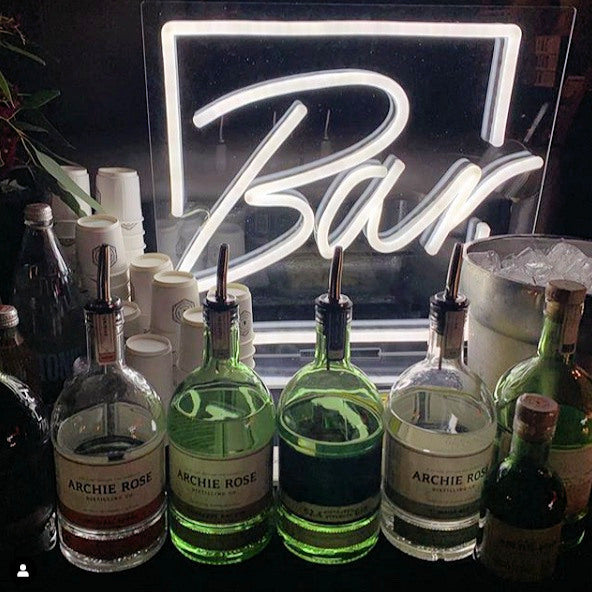 Freestanding Neon Bar Light shown on the bar at an event - made by @customneon