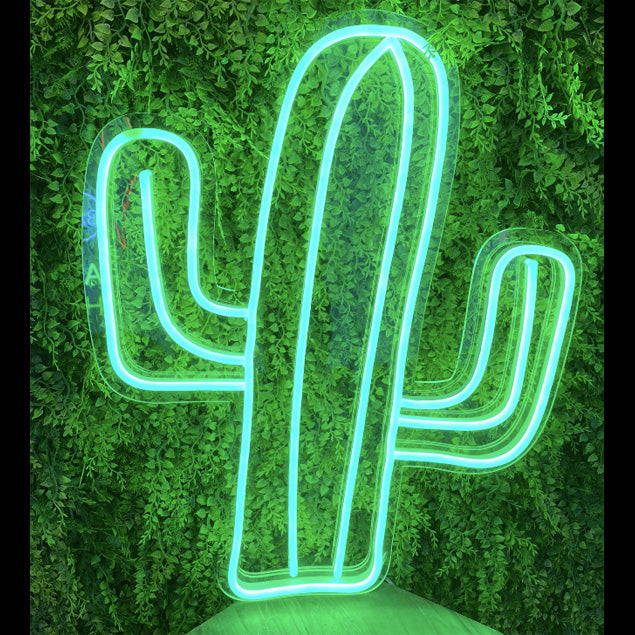 Cactus neon art in green LED flex shown in front of greenery - from Custom Neon