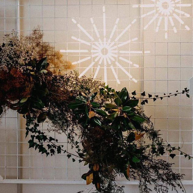 Christmas Star LED Neon Light shown on a frame with seasonal florals - photo from CustomNeon.com
