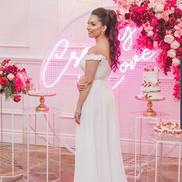 Crazy In Love Wedding Sign in brilliant LED neon flex shown in pink with the beautiful bride