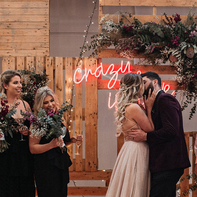 Crazy in Love LED neon wedding sign on a wooden/floral  background for wedding photo shoots - from Custom Neon