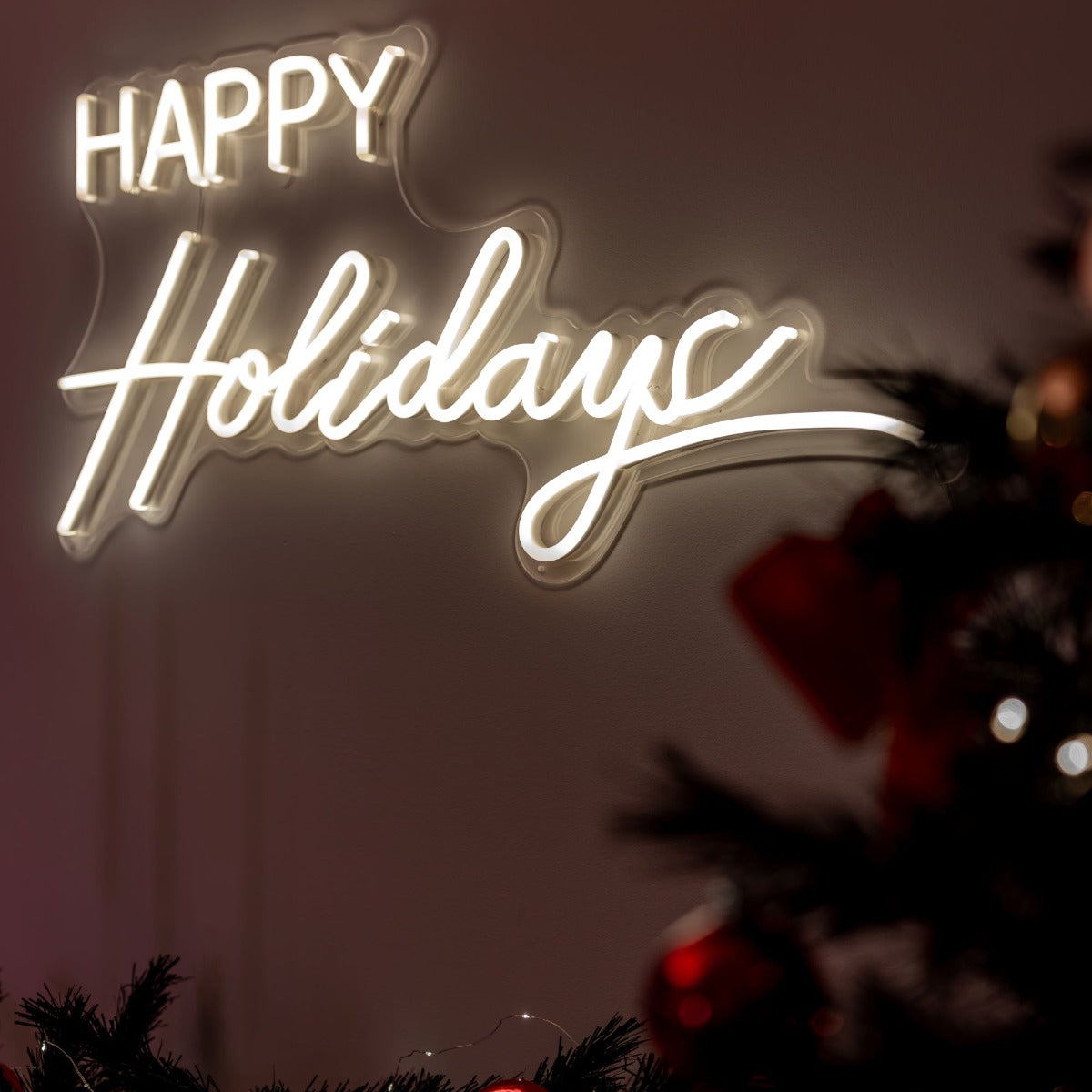 Happy Holidays warm white LED neon light sign above a modern fireplace with Christmas presents @customneon