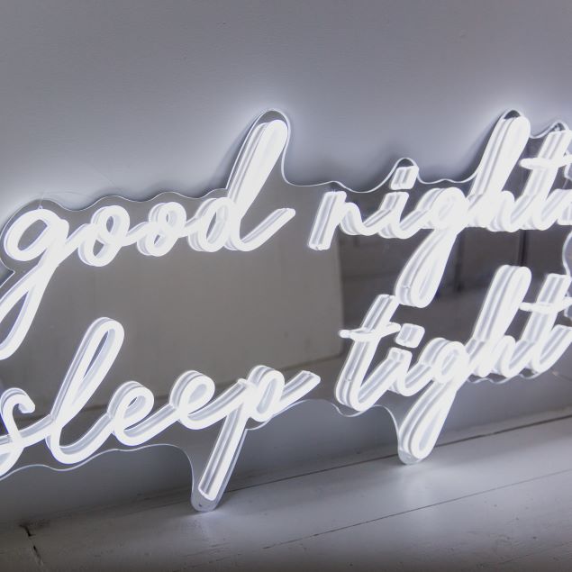 Good Night Sleep Tight white LED on silver mirrored backing shown in slightly dim light - CUSTOM NEON® 