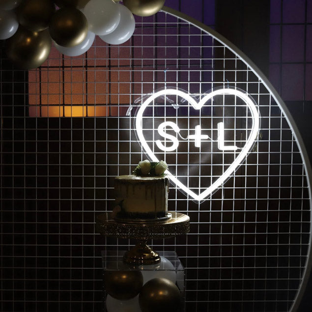Personalized Heart Neon Sign in LED Flex with clear acrylic background displayed with balloons and wedding cake - photo from CustomNeon.com