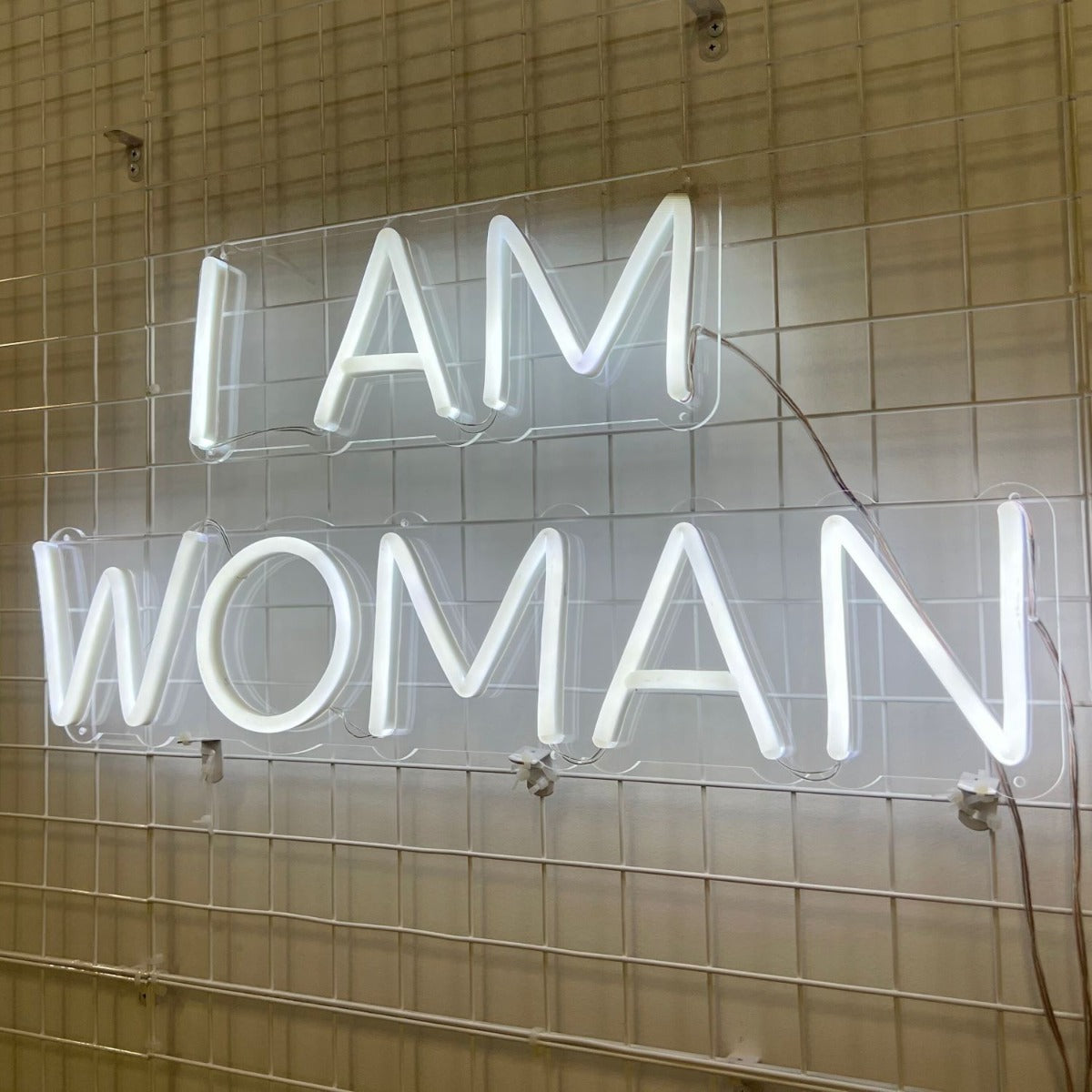 I Am Woman white Custom Neon® sign on pink wall