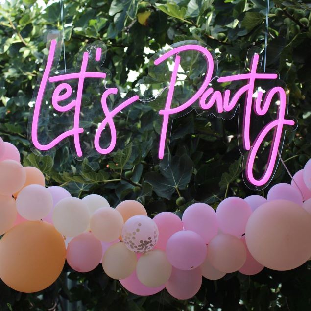 Let's Party pink lightup sign shown above a balloon arch - from Custom Neon