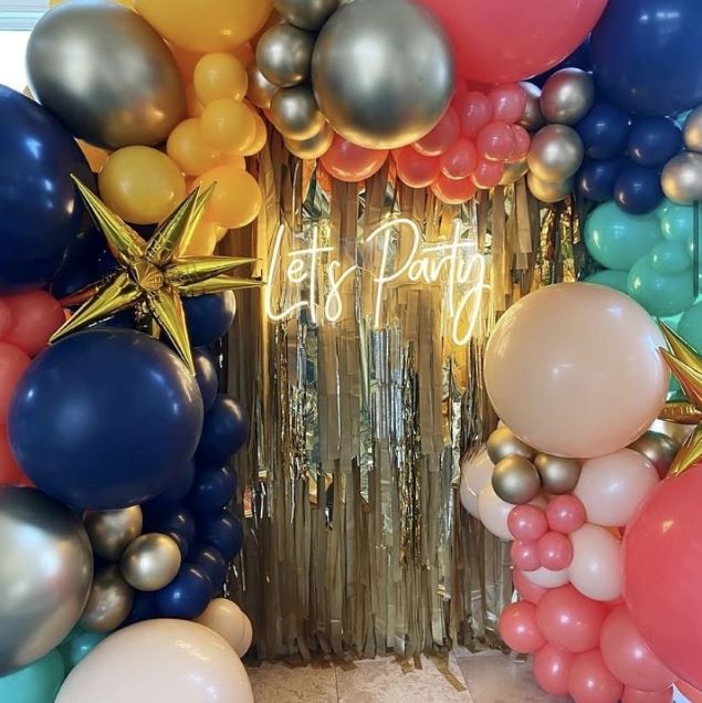 Let's Party LED neon light in soft white surrounded by giant balloons and party decor - from Custom Neon® @customneon
