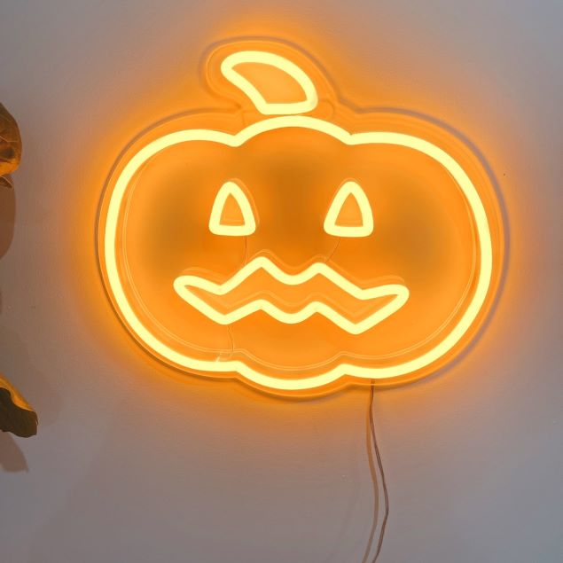 Spooky Light Up Jack O Lantern in pumpkin orange shown illuminated in a bright setting - CUSTOM NEON® Halloween Decorations