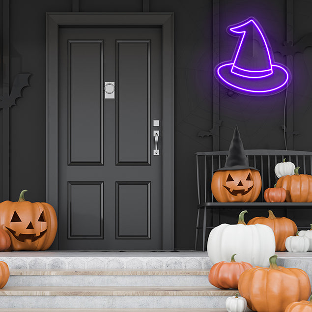 LED Neon Purple Witch Hat shown outside on a dark wall with other Halloween decorations -  CUSTOM NEON®