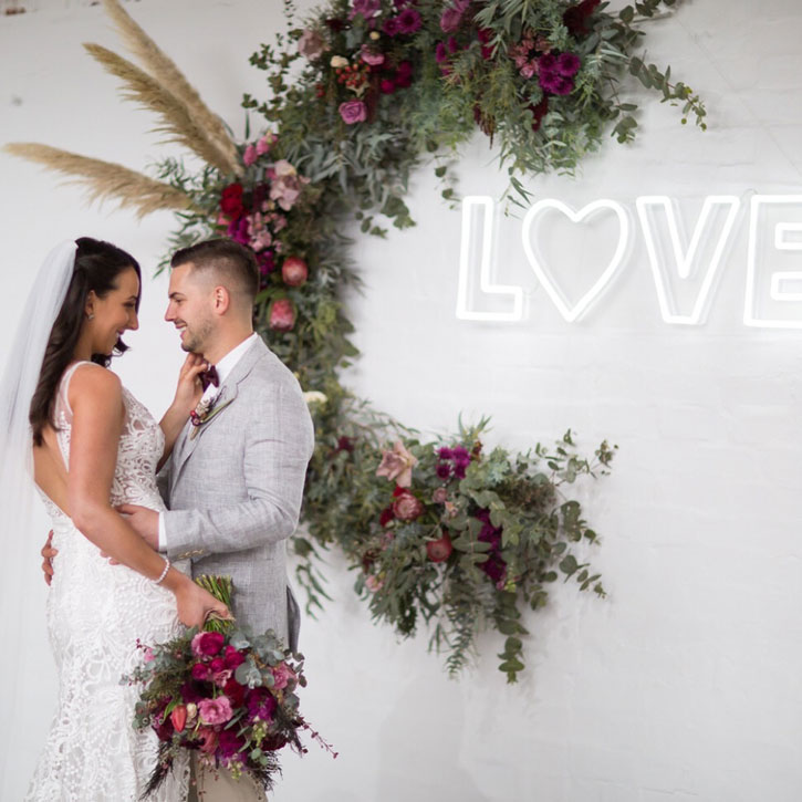 Love LED Neon Letter Light mounted on brick wall
 - photo from CustomNeon.com