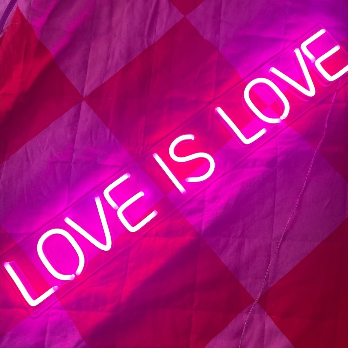 Custom Neon® signs and artwork mounted above a bed