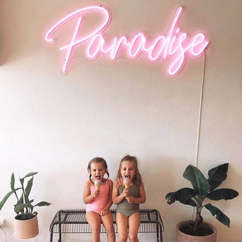 Paradise Neon Sign shown in pink at an ice cream parlor - from CustomNeon.com