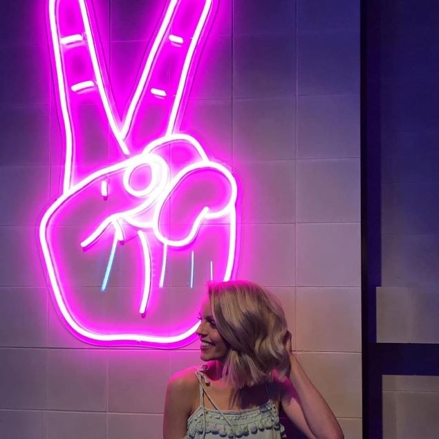 Pink neon peace sign (hand) on a tile wall - from Custom Neon