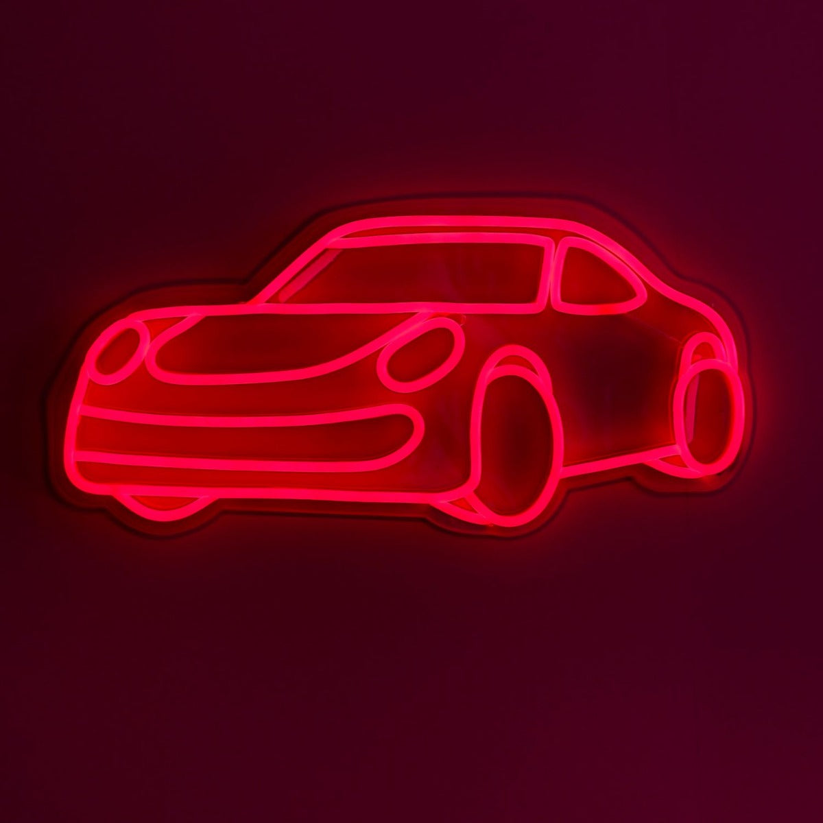 CUSTOM NEON® Garage Signs: Red Porche LED wall art shown illuminated against a dark background in dim light