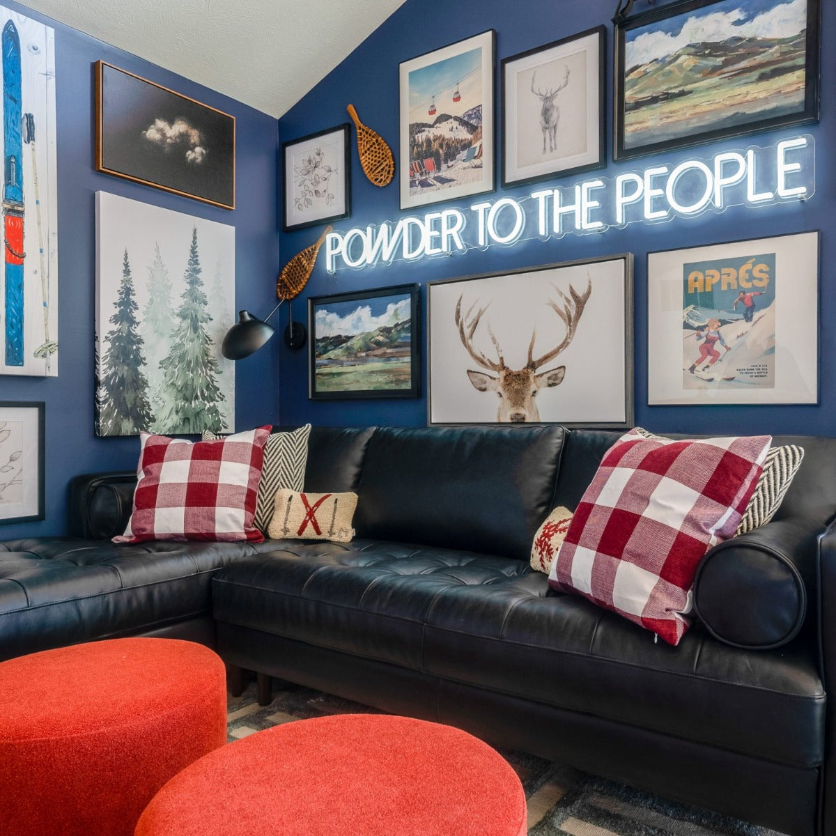 Powder to the People white LED neon sign on a blue feature wall above a black leather couch in a living room - CUSTOM NEON™ x SOMERLED COLLECTION