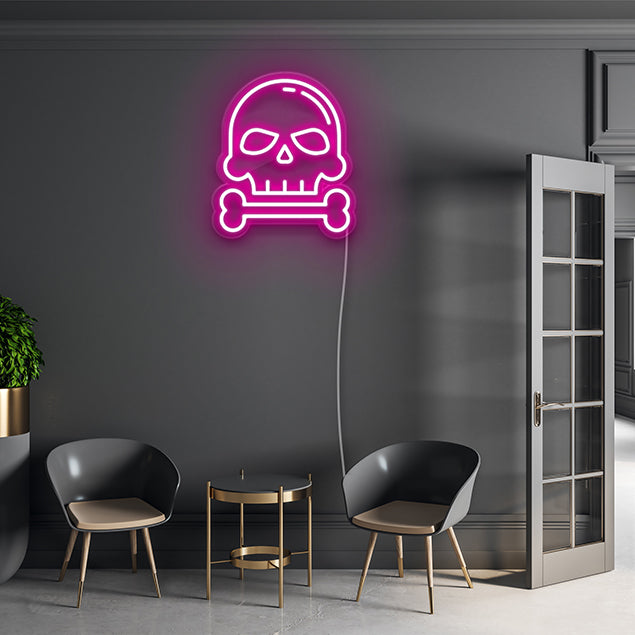 Skull and Bone pink light-up wall art shown on dark inside wall - by Custom Neon®