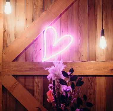 Small LED neon art for weddings and home decor shown leaning against the wall - photo from CustomNeon.com