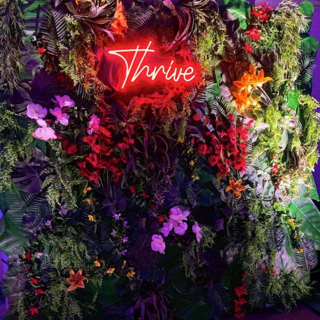 Thrive red Custom Neon® light surrounded by florals @csdesignandevents