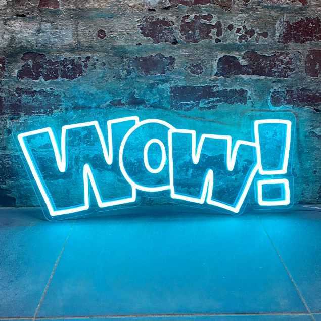 WOW! bright blue light sign against a brick wall from Custom Neon®